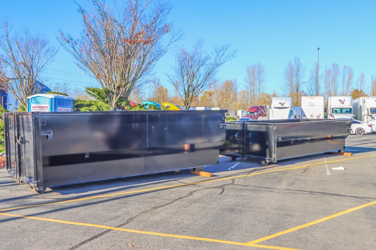 Professional dumpster rental service with roll-off container on residential driveway in New Gloucester